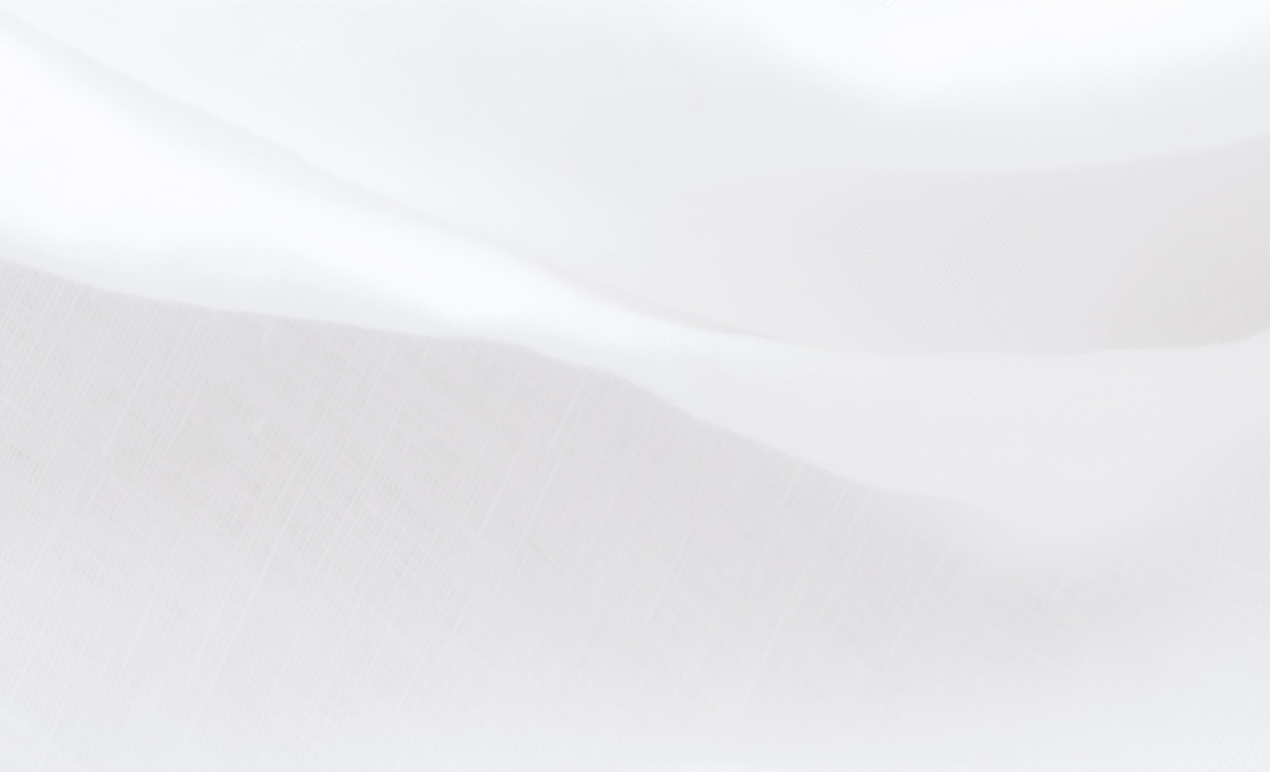 Soft, flowing white fabric texture background.