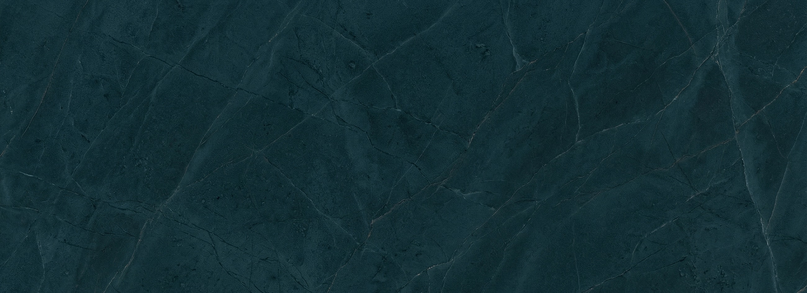 Dark textured stone background with cracks and veins.