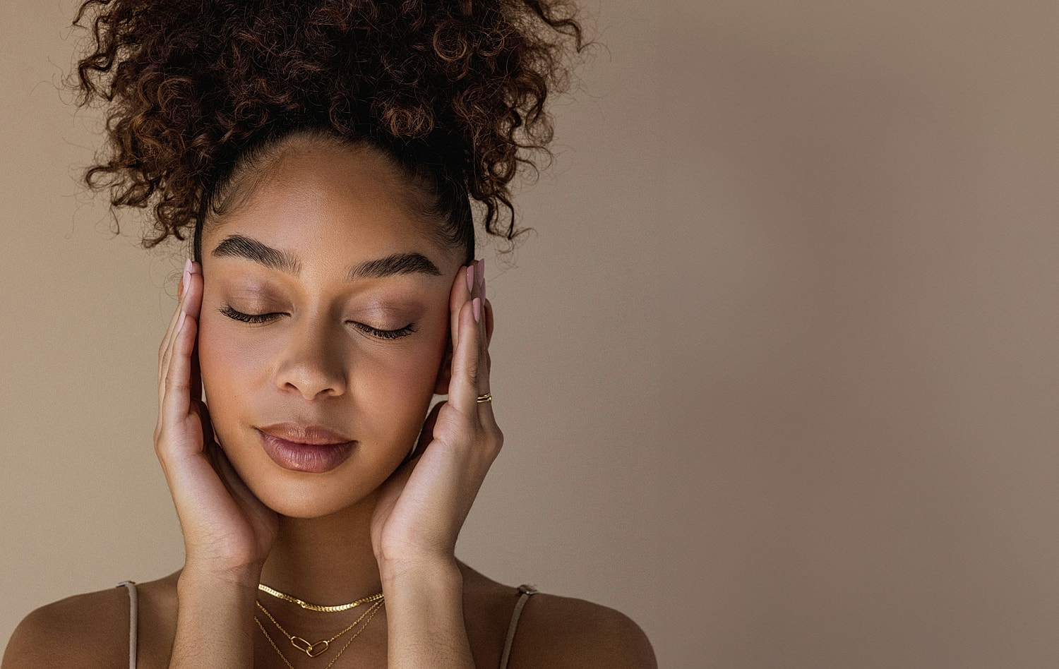 Young woman relaxing with eyes closed, serene expression.