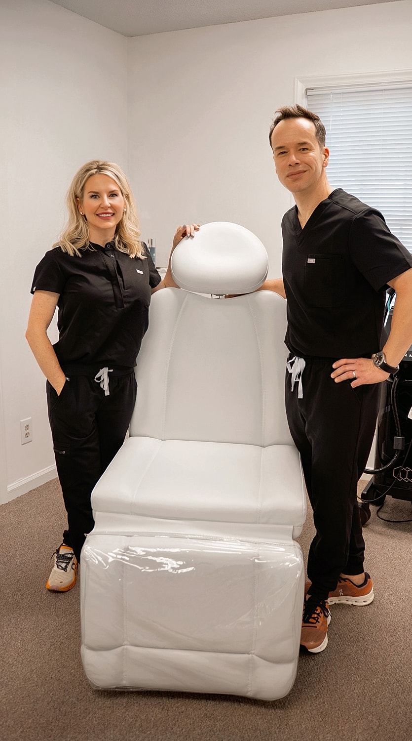 Medical professionals beside a treatment chair.